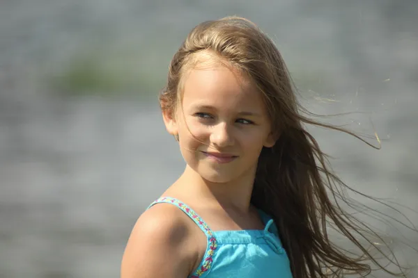 Porträtt av ett barn flicka med att utveckla hår i vinden — Stockfoto