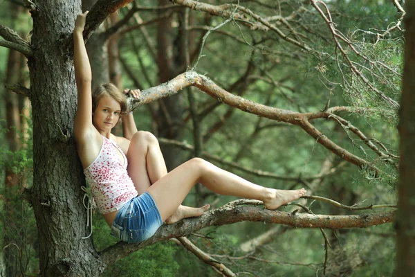 Lány ül egy fa — Stock Fotó