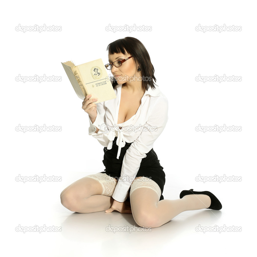 Attractive girl dressed in erotic stockings reading a book