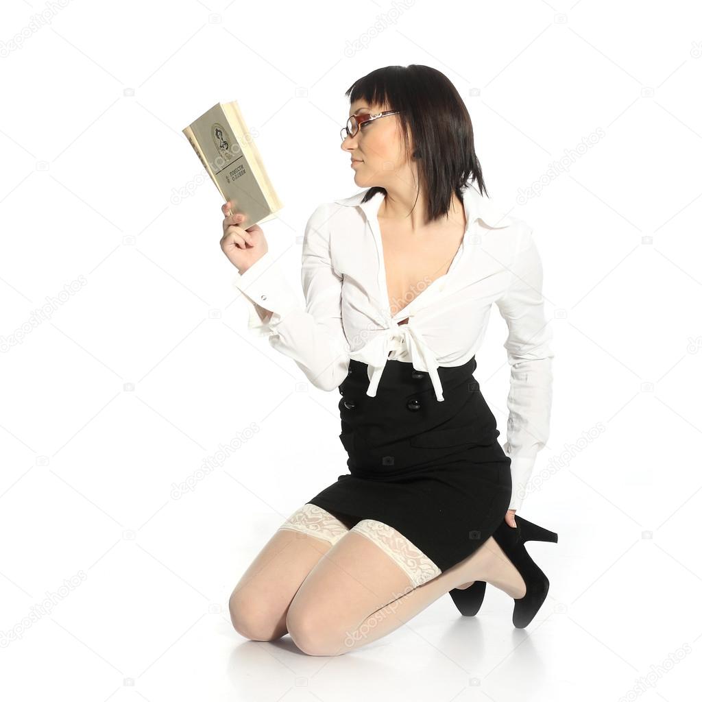 Attractive girl dressed in erotic stockings reading a book