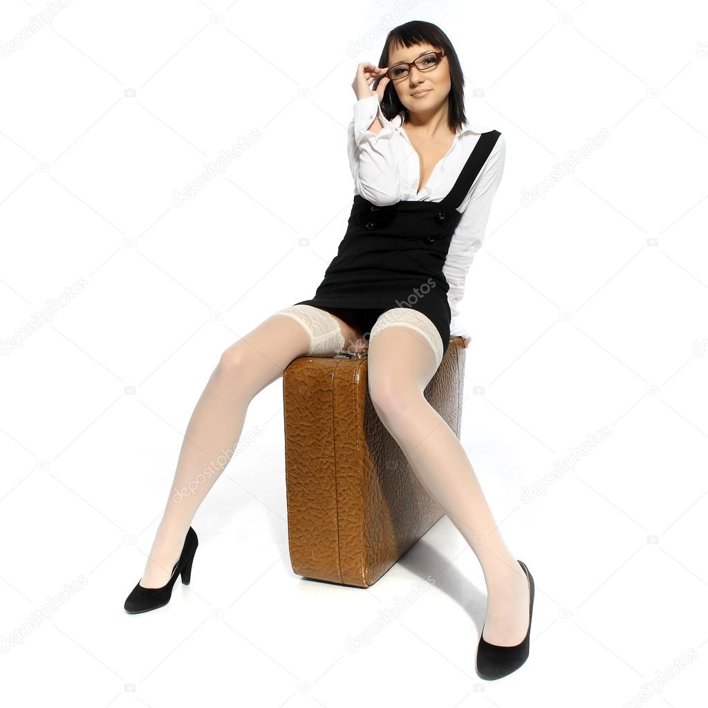 Beautiful girl in white stockings with suitcase