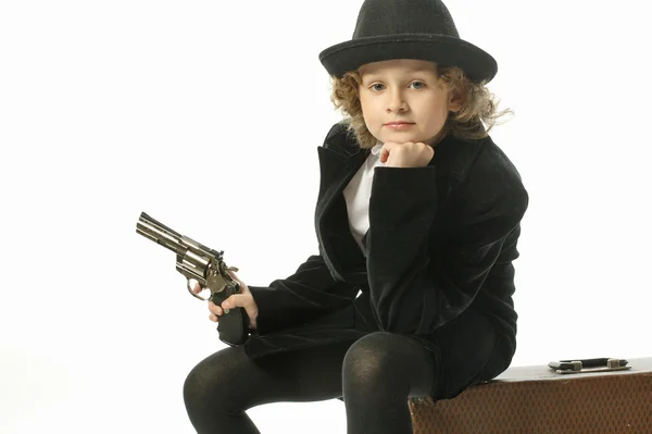 Teen girl in a hat with a gun — Stock Photo, Image