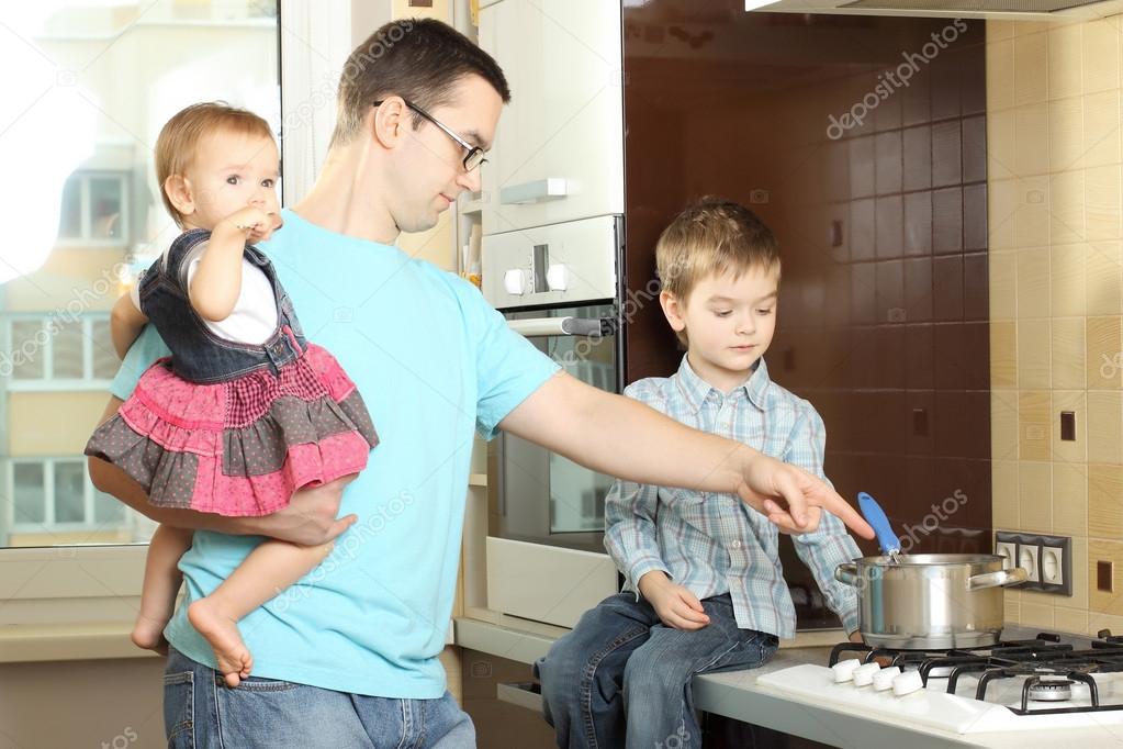 happy father with children in the kitchen