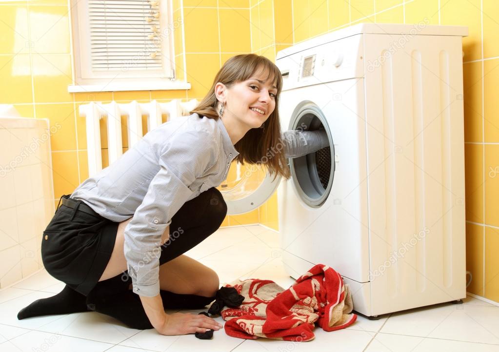 Ordinary simple beautiful girl near a washing machine