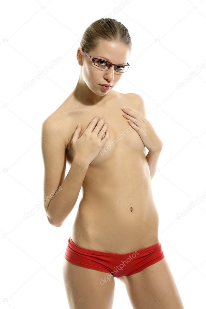 Naked slim girl in glasses like a teacher