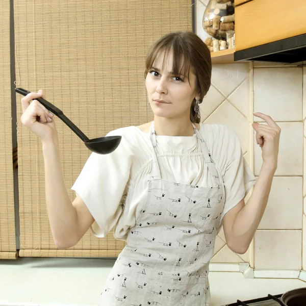 Nice normal girl in a light dress tries to scoop food — Stock Photo, Image