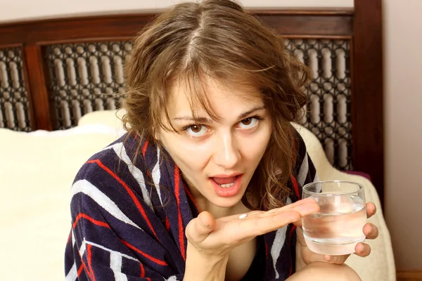 Woman in a bathrobe suffering from a headache — Stock Photo, Image