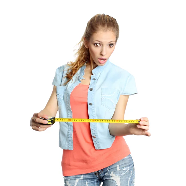 Concerned girl looks down at tape measure — Stock Photo, Image