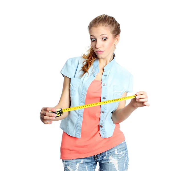 Concerned girl looks down at tape measure — Stock Photo, Image