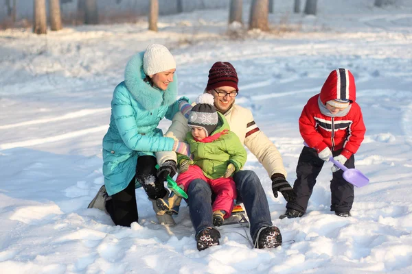 Attractive family having fun in a winter park — Stock Photo, Image