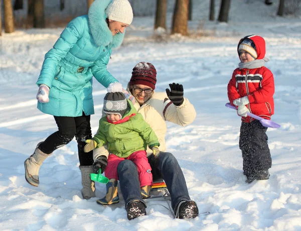 Attractive family having fun in a winter park — Stock Photo, Image