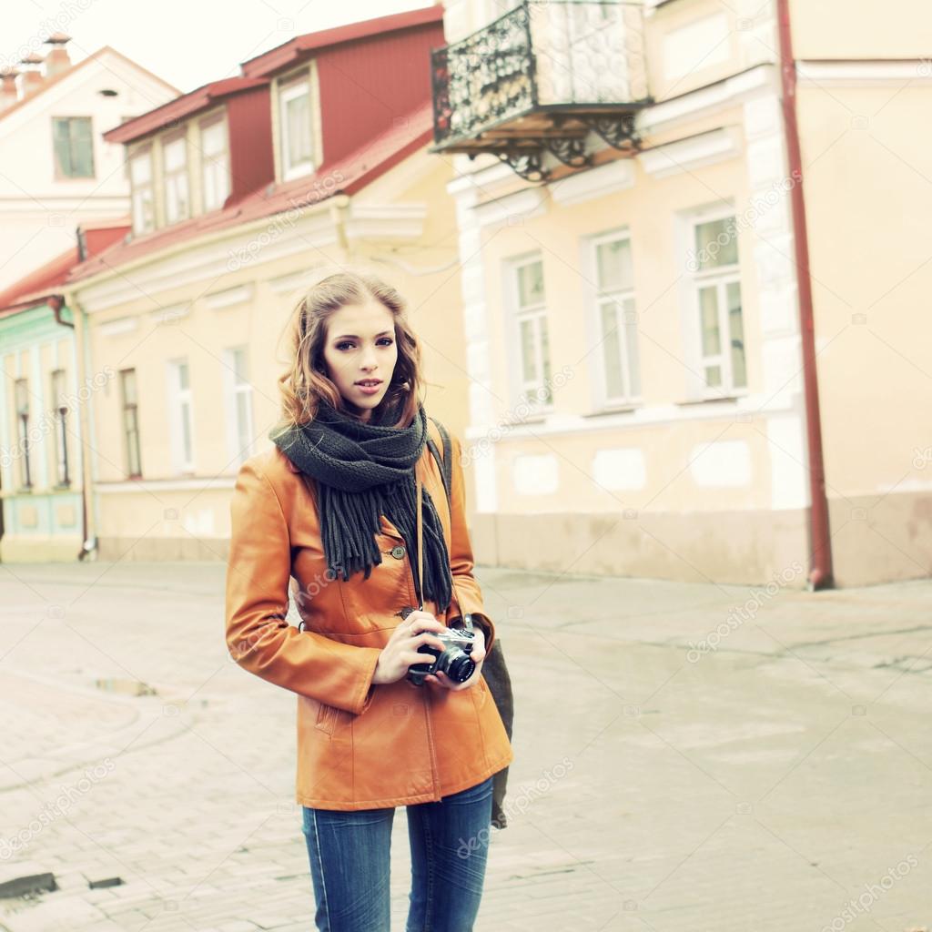 Beautiful girl traveling with a vintage camera