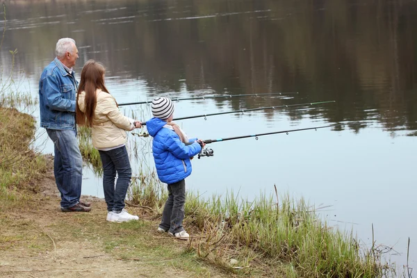 Grandfather and grandchildren are fishing