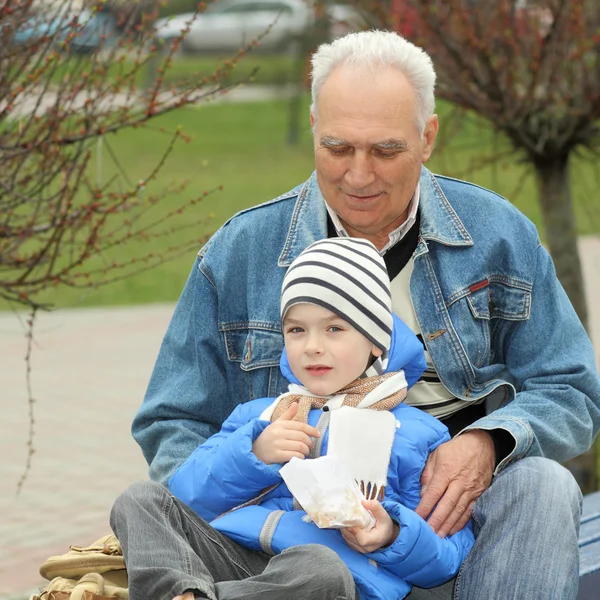 Дедушка и внук едят — стоковое фото