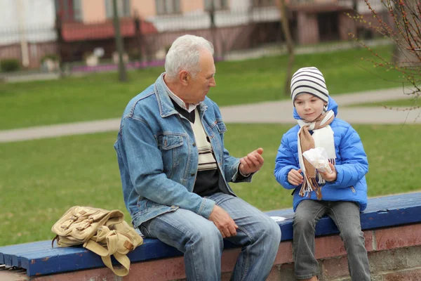 Grandfather and grandson eating — Stock Photo, Image