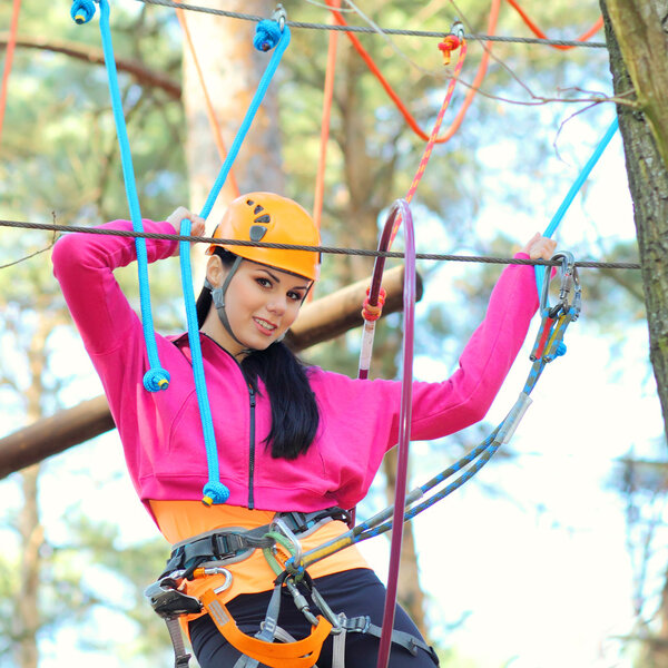 Beautiful girl in the outfit climbing climbs