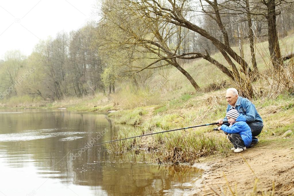 Grandfather and grandson are fishing