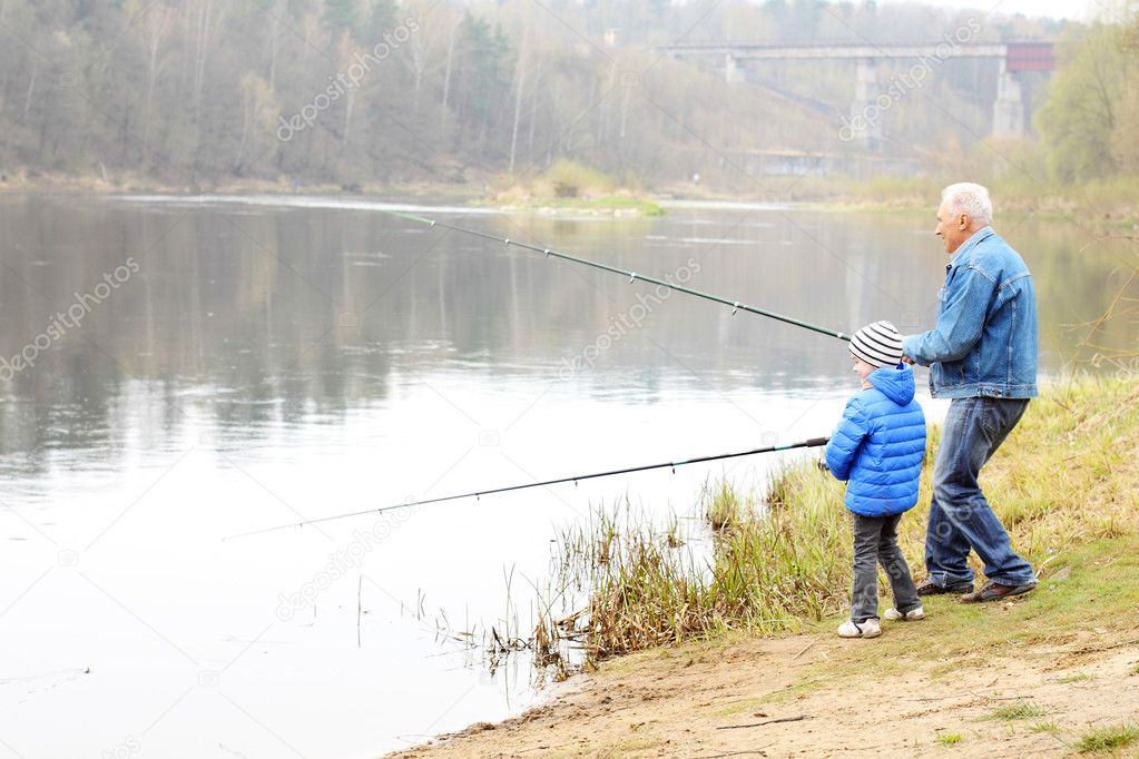 Grandfather and grandson are fishing