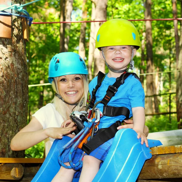 Mom and son climbing the trees