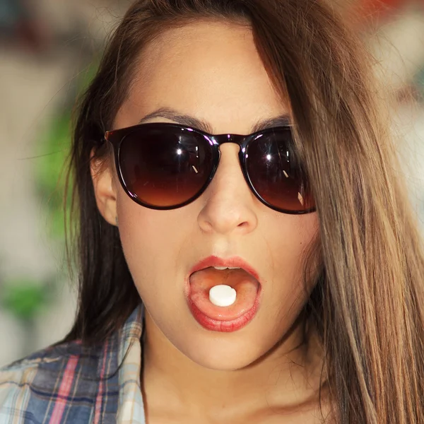 Fashionable girl going to swallow pill Stock Photo