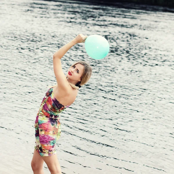 Woman on water with balloon — Stock Photo, Image