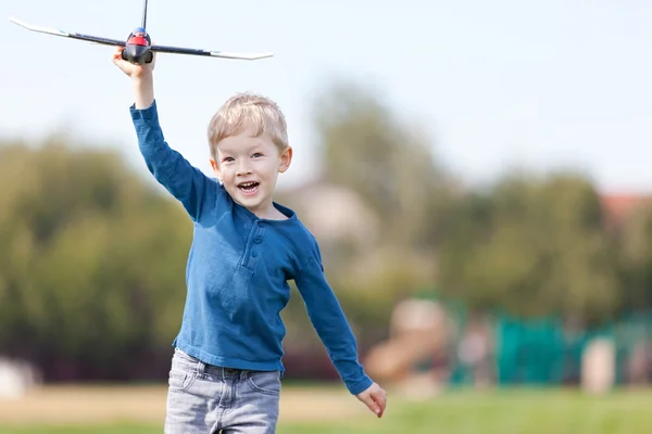 Criança brincando com um avião — Fotografia de Stock