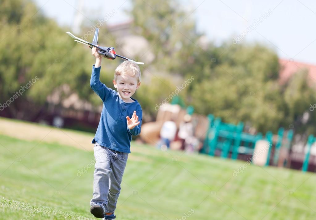 child playing with a plane