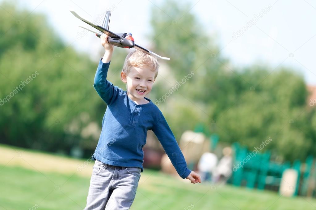 boy playing his toy plane