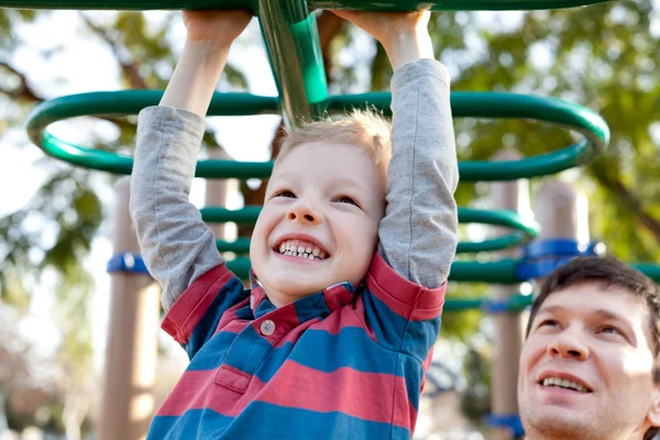 Family at kids playground — Stock Photo, Image