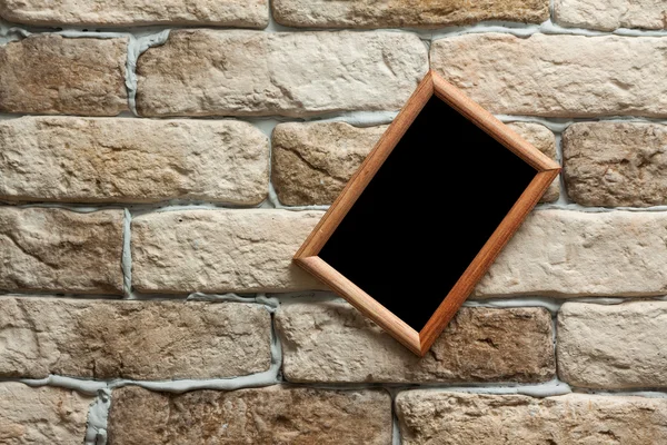 Photo frame on brick wall — Stock Photo, Image