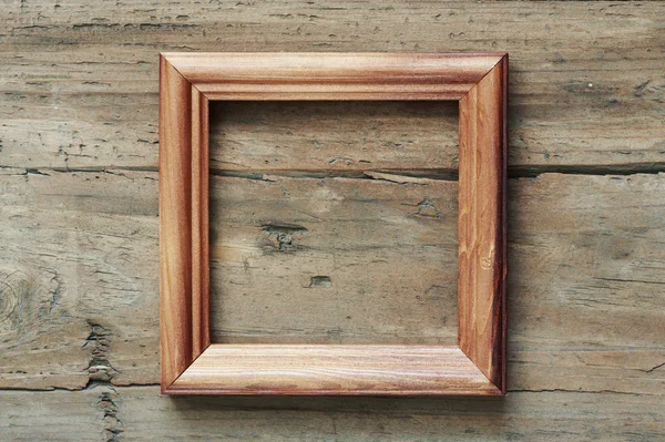 Photo frame on wooden wall — Stock Photo, Image