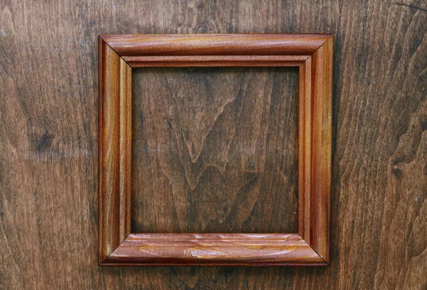 Photo frame on wooden wall — Stock Photo, Image