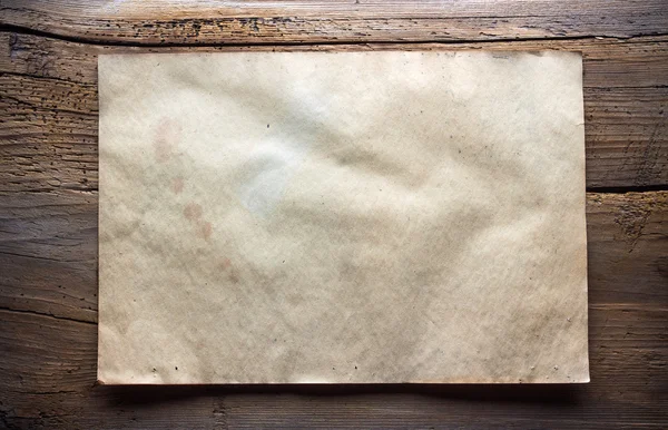 Бумага на деревянном фоне — стоковое фото