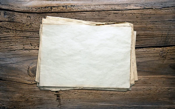 Old papers on wooden background — Stock Photo, Image