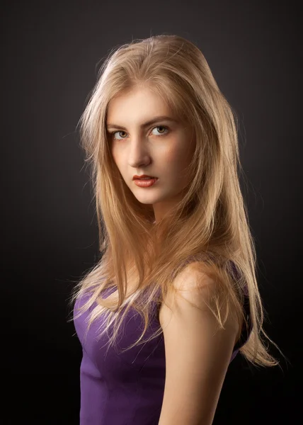 Blonde girl in purple dress Stock Photo