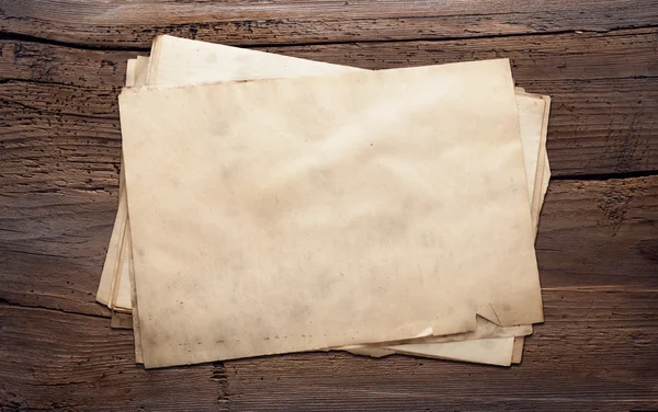Old papers on wooden background Royalty Free Stock Images