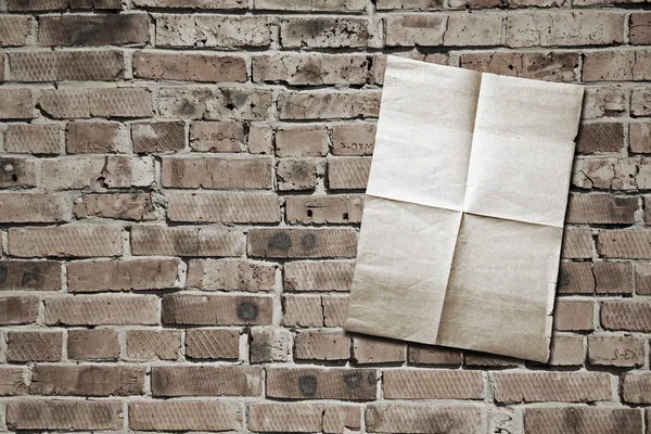 Paper on brickwall — Stock Photo, Image