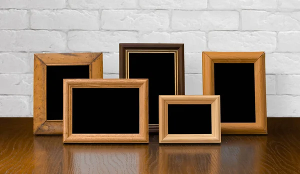 Old Photo Frames Wooden Table White Brick Wall — Stock Photo, Image