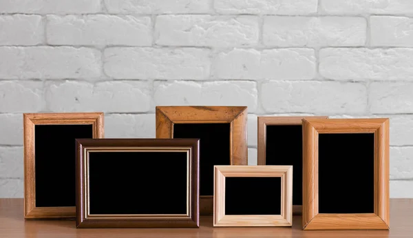 Old Photo Frames Wooden Table White Brick Wall — Stock Photo, Image