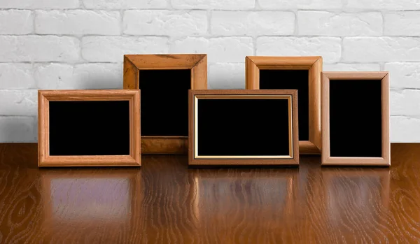 Old Photo Frames Wooden Table White Brick Wall — Stock Photo, Image