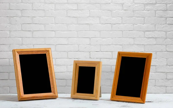 Old Photo Frames Wooden Table White Brick Wall — Stock Photo, Image