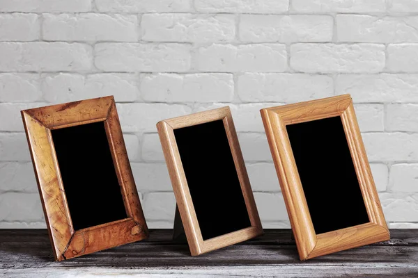 Old Photo Frames Wooden Table White Brick Wall — Stock Photo, Image