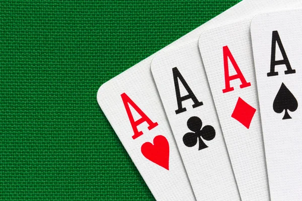 Four aces over green textile background Royalty Free Stock Photos