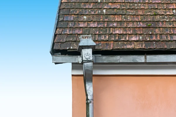 Old tile roof and rain gutter