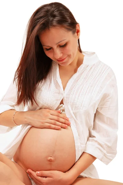 Pregnant woman with hands over tummy Stock Photo