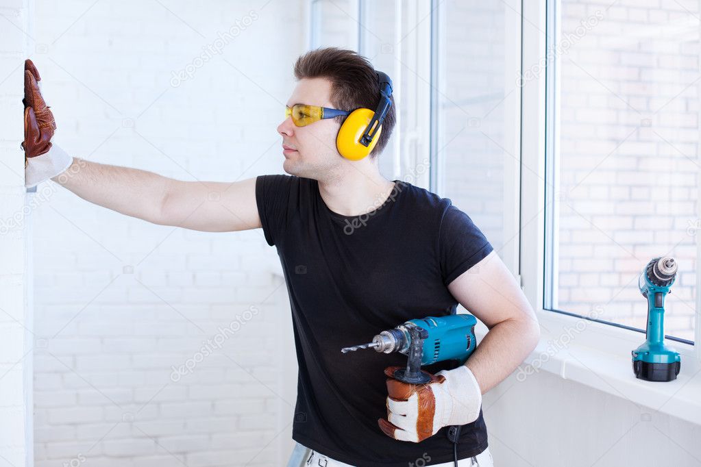 Man worker with drill