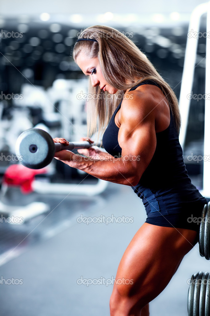 Close-up of Strong Muscular Arm of Woman Bodybuilder Who Train on Simulator  in Fitness Club Stock Photo - Image of bodybuilding, bodybuilder: 204288532