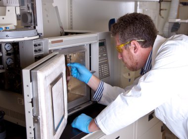 Scientist prepares chromatograph oven installing column clipart