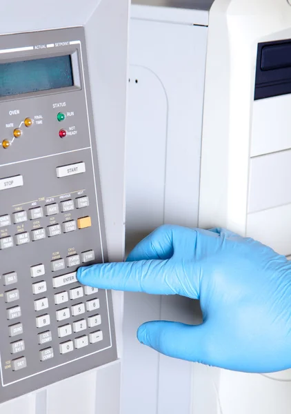 Scientist sets chromatograph oven temperature — Stock Photo, Image