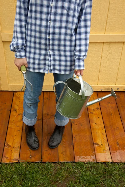 Woman holds gardening tools — Stock Photo, Image